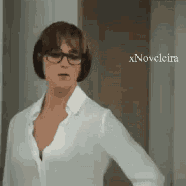 a woman wearing glasses and a white shirt is standing in front of a door with xnovelaira written on the bottom