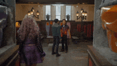 a group of people standing in a room with lockers that say ' sd ' on them