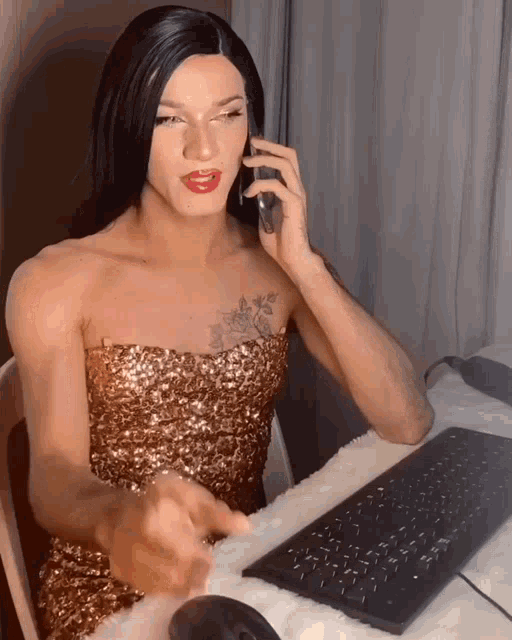 a woman in a gold dress is talking on a phone