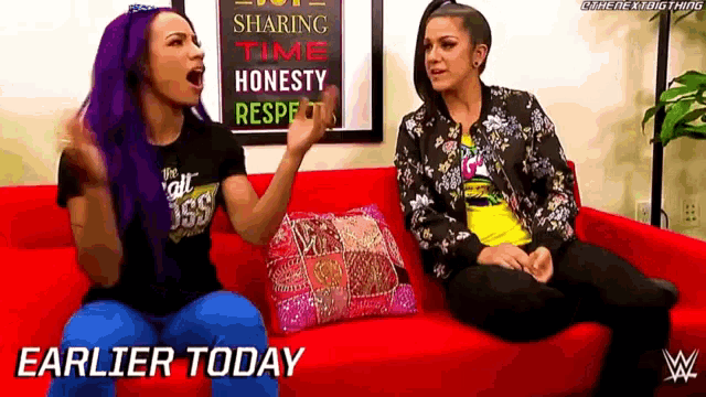 two women are sitting on a red couch and the words earlier today are on the bottom