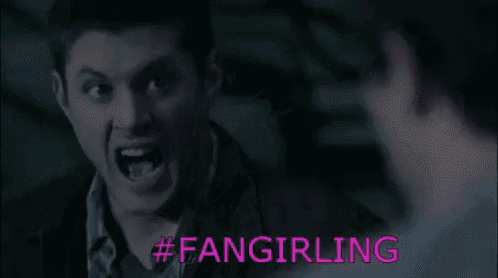 a man is screaming at another man with the words `` fangirling '' written on the bottom .