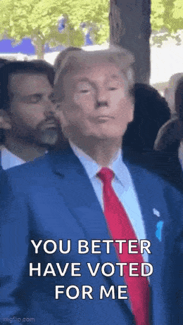 donald trump is wearing a blue suit and red tie and making a funny face .