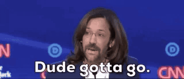 a man with long hair and a beard says dude gotta go