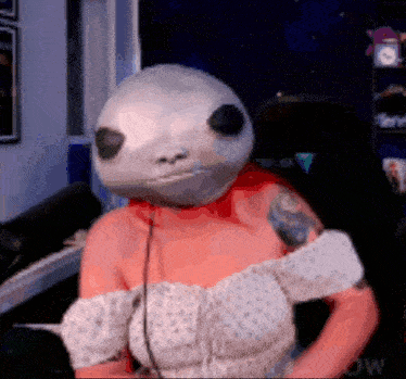 a woman wearing a mask that looks like a soccer ball on her head