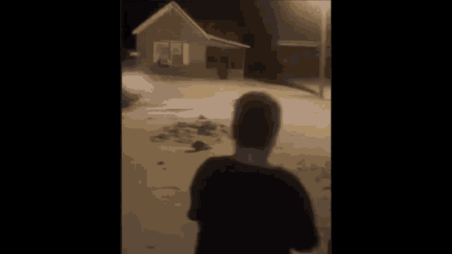 a blurry picture of a man standing on a street .
