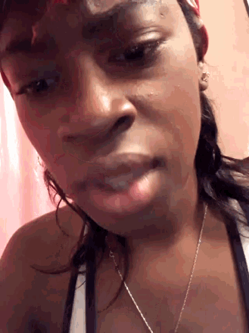 a close up of a woman 's face with a necklace