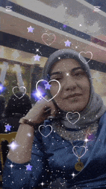 a woman in a blue dress with hearts and stars surrounding her