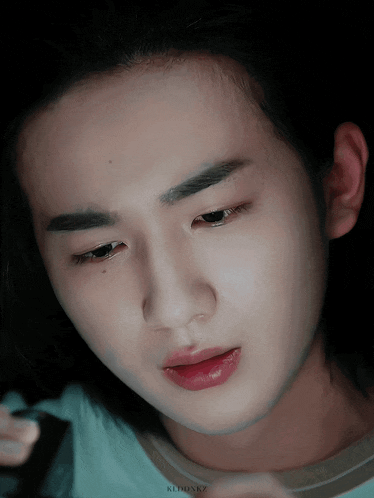 a close up of a person 's face with the name kedonkz written on the bottom