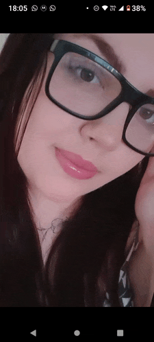 a close up of a woman wearing glasses and a tattoo