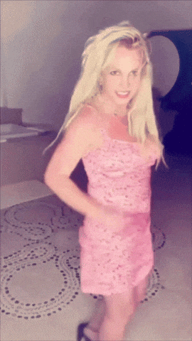 a blonde woman in a pink dress is standing on a tiled floor
