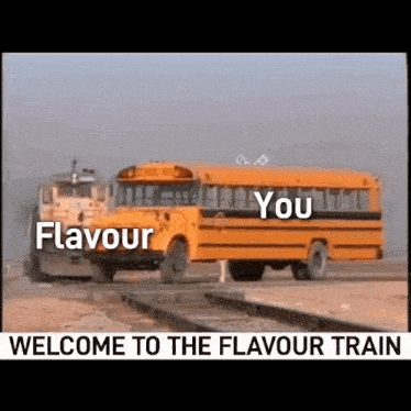 a school bus is driving down train tracks next to a bulldozer .