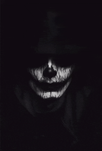 a black and white photo of a person 's face with a skeleton face paint