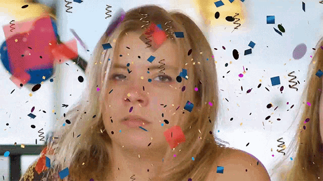 a woman 's face is surrounded by confetti and swirls