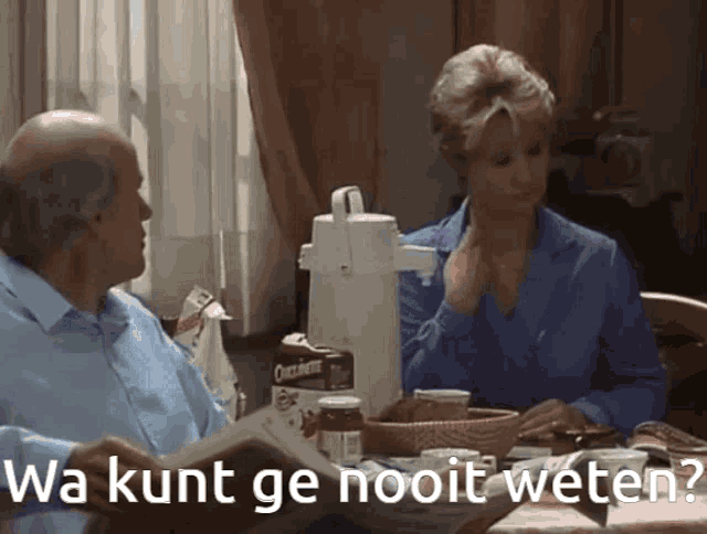 a man and woman are sitting at a table with the words wa kunt ge nooit weten on the bottom