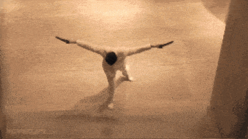 a man with his arms outstretched is in a movie clip