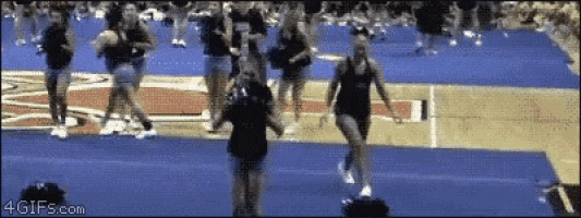 a group of cheerleaders are performing on a basketball court and the website 4gifs.com is visible in the corner