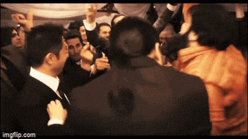 a man in a suit is standing in a crowd of people with a watermark that says imgflip.com on the bottom