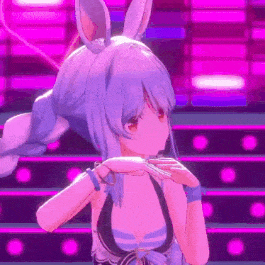 a girl with bunny ears is dancing on a stage .