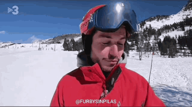 a man wearing a ski helmet and goggles with the number 3 on the bottom