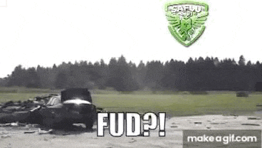 a car is being destroyed by a rocket in a field with trees in the background .
