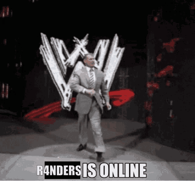 a man in a suit and tie is dancing in front of a wwe logo