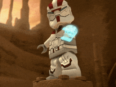 a statue of a lego figure with a glowing hand