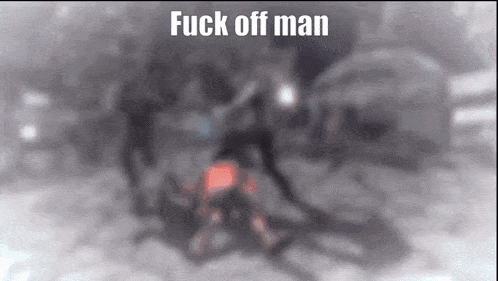a blurry picture of a man laying on the ground with the words " fuck off man " above him