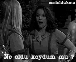 two women are talking in a black and white photo with the words ne oldu koydum mu on the bottom