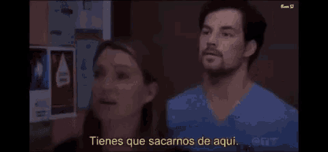 a man and a woman are standing next to each other with a caption that says tienes que sacarnos de aqui