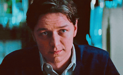 a close up of a man 's face with a slight smile on his face