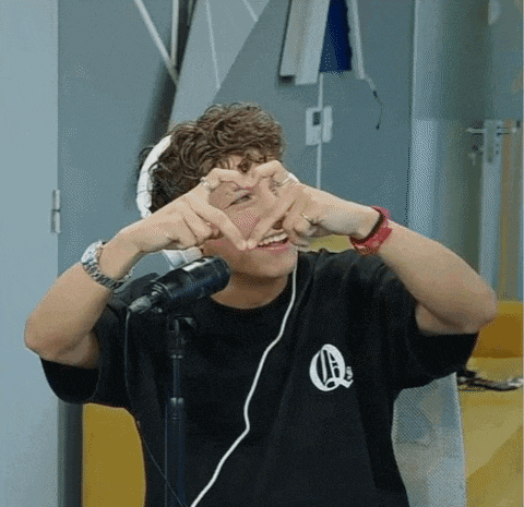 a man making a heart shape with his hands