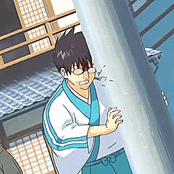 a man in a kimono is standing next to a pole and crying