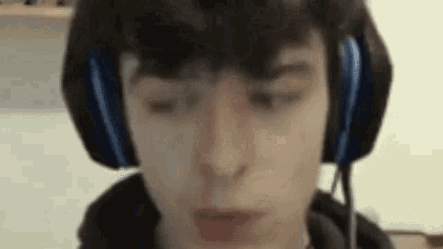 a close up of a person wearing headphones and a microphone .