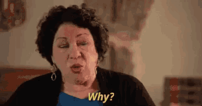 a woman is making a funny face and saying `` why '' .