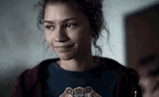 a close up of a woman wearing a hoodie and a t-shirt