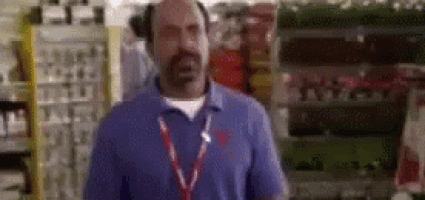 a man with a beard is standing in a store .