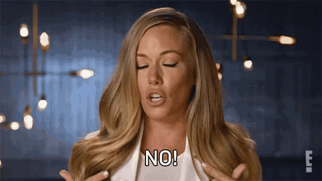 a woman with long blonde hair says no with her eyes closed