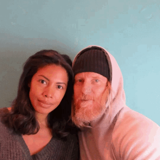 a man with a beard and a woman posing for a photo