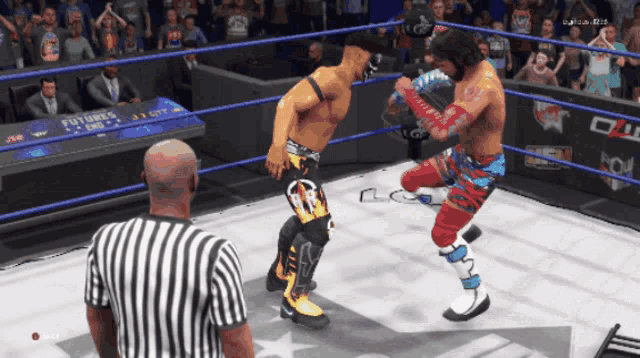 two wrestlers are in a ring with a referee and a sign that says futures ends