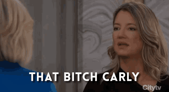 a woman talking to another woman with the words that bitch carly behind her