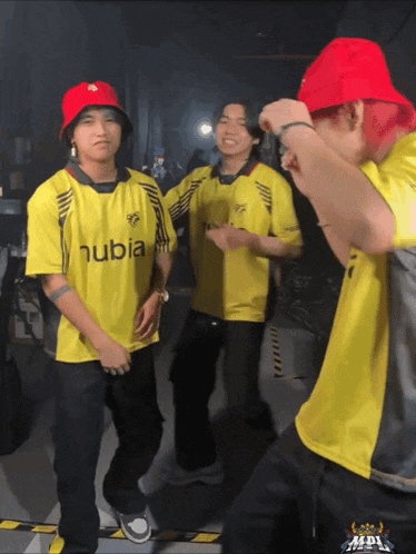 a man wearing a red hat and a yellow shirt with the word hubia on it