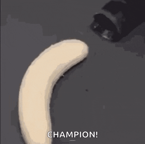a close up of a banana being peeled with the words `` champion '' written on it .