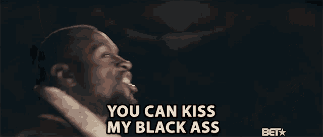 a man says " you can kiss my black ass " in front of a bet logo