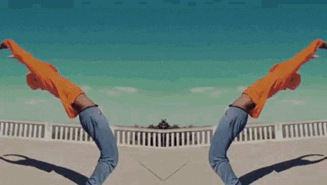 a man in an orange hoodie is jumping in the air with bubbles in the background