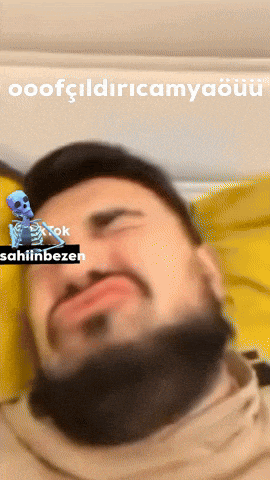 a man with a beard is laying on a bed with a skeleton behind him and the words sahiin bezen