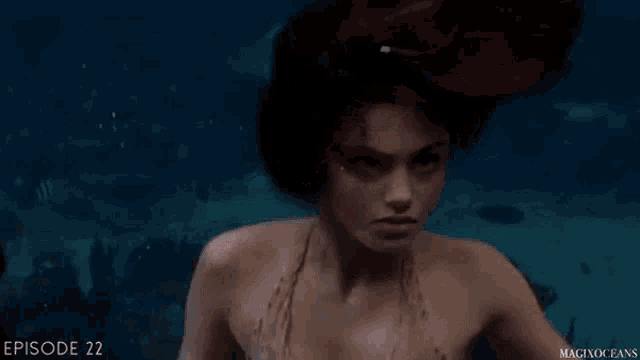 a woman in a bikini is swimming underwater with the words episode 22 visible in the background