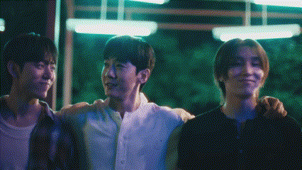 three young men are standing next to each other with their arms around each other 's shoulders .