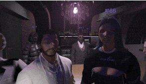 a man in a white suit stands next to a woman in a black shirt with the number 156 on the bottom