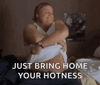 a woman is sitting on a bed with her arms around her stomach .