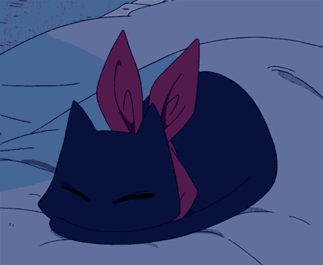 a black cat with a scarf around its neck is laying on a bed